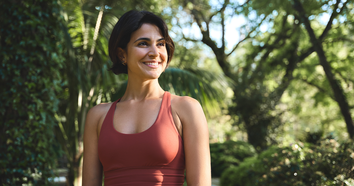 woman standing and smiling.