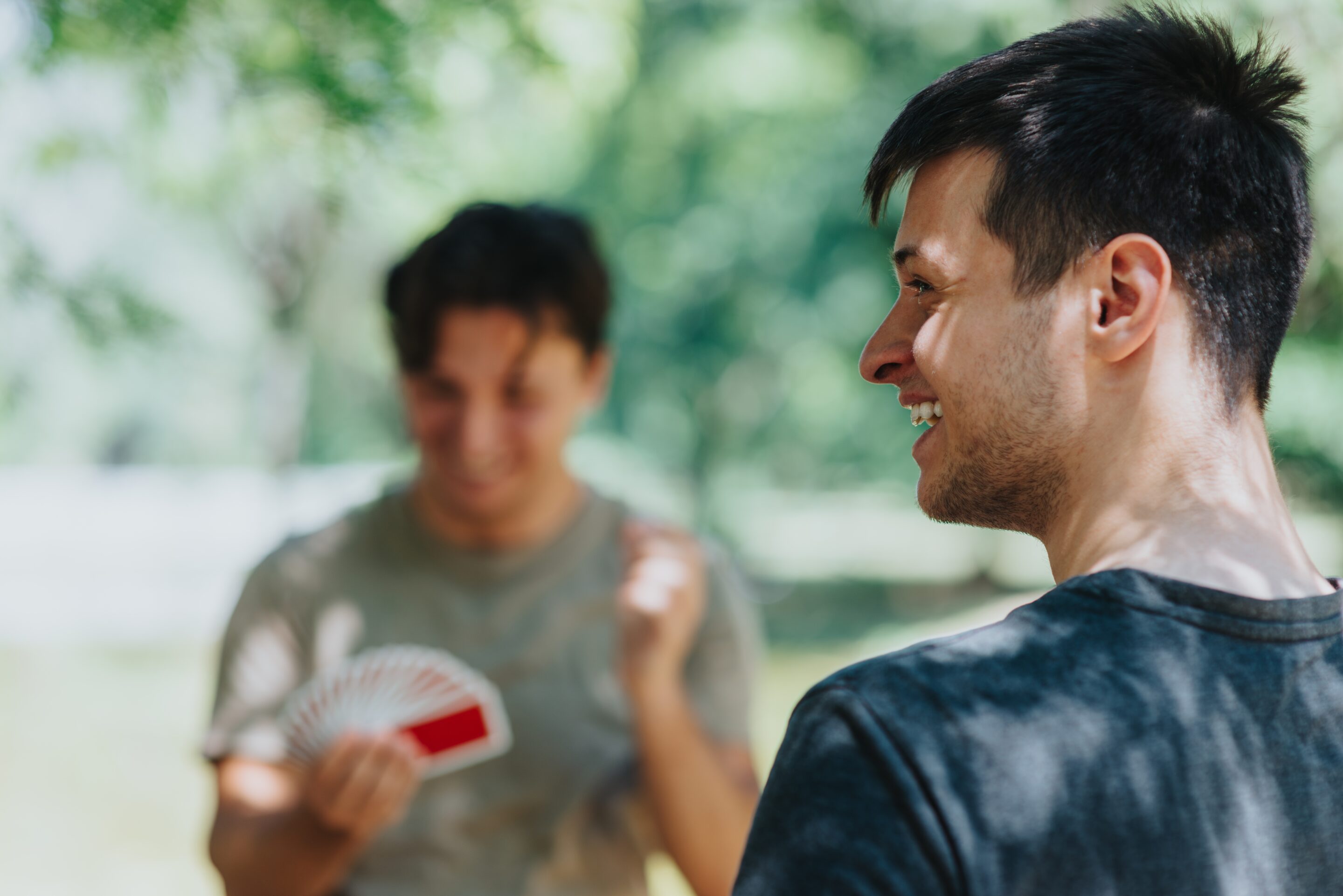 Two males playing a card game after receiving mental health treatment in Portland