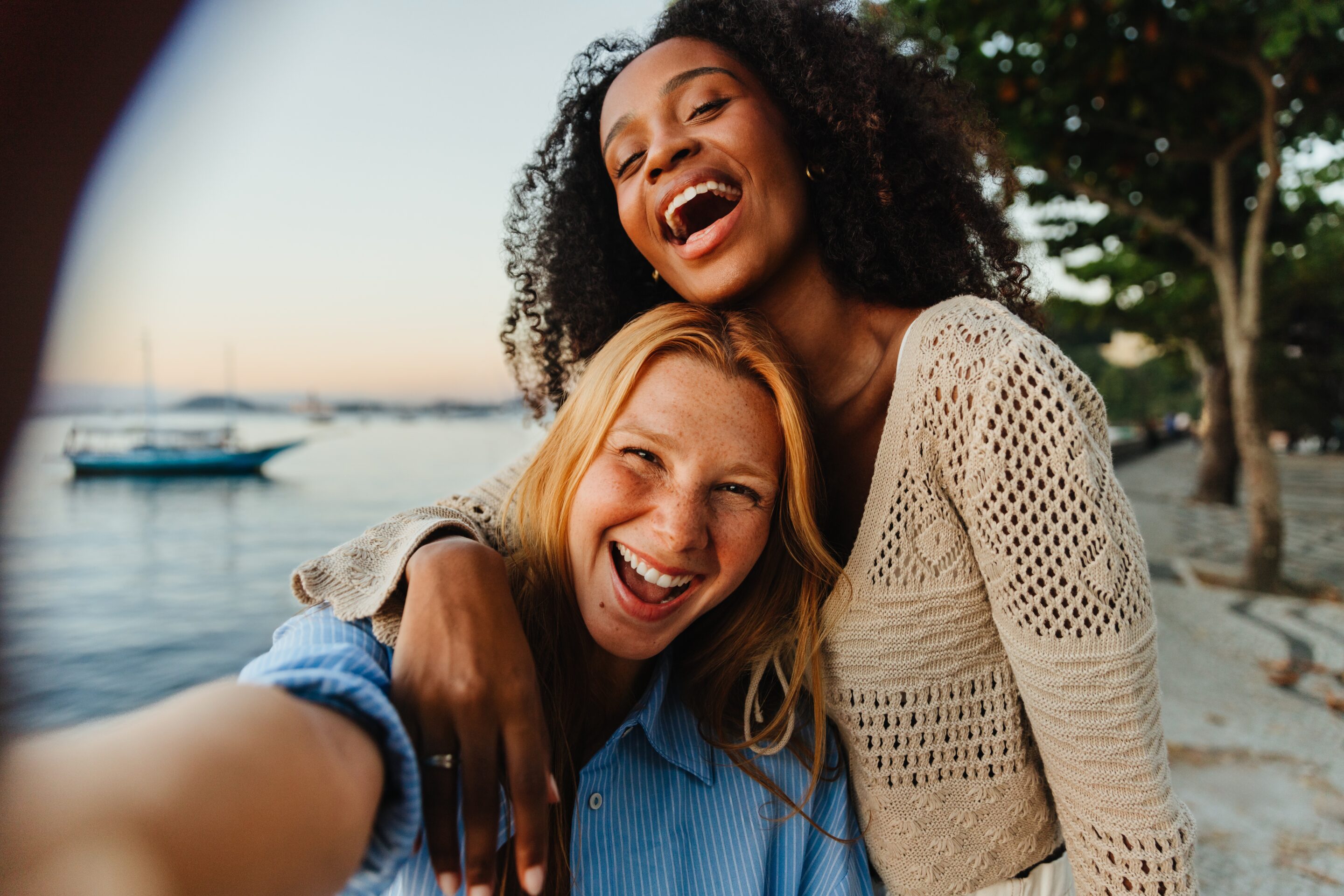 Two girls smiling at the camera after having talk therapy for anxiety and depression